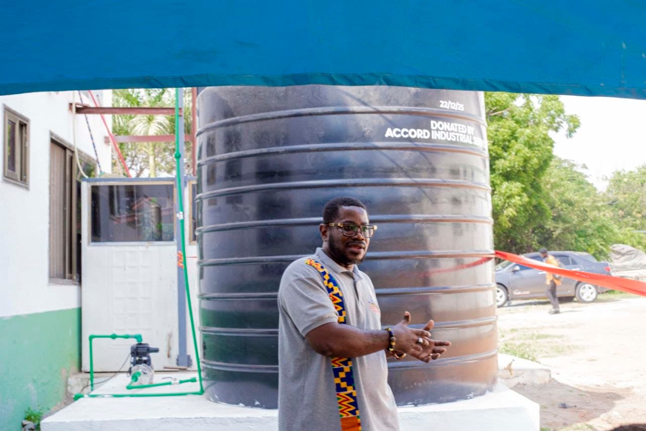 Large black Polytank labelled Donated by Accord Industrial Services