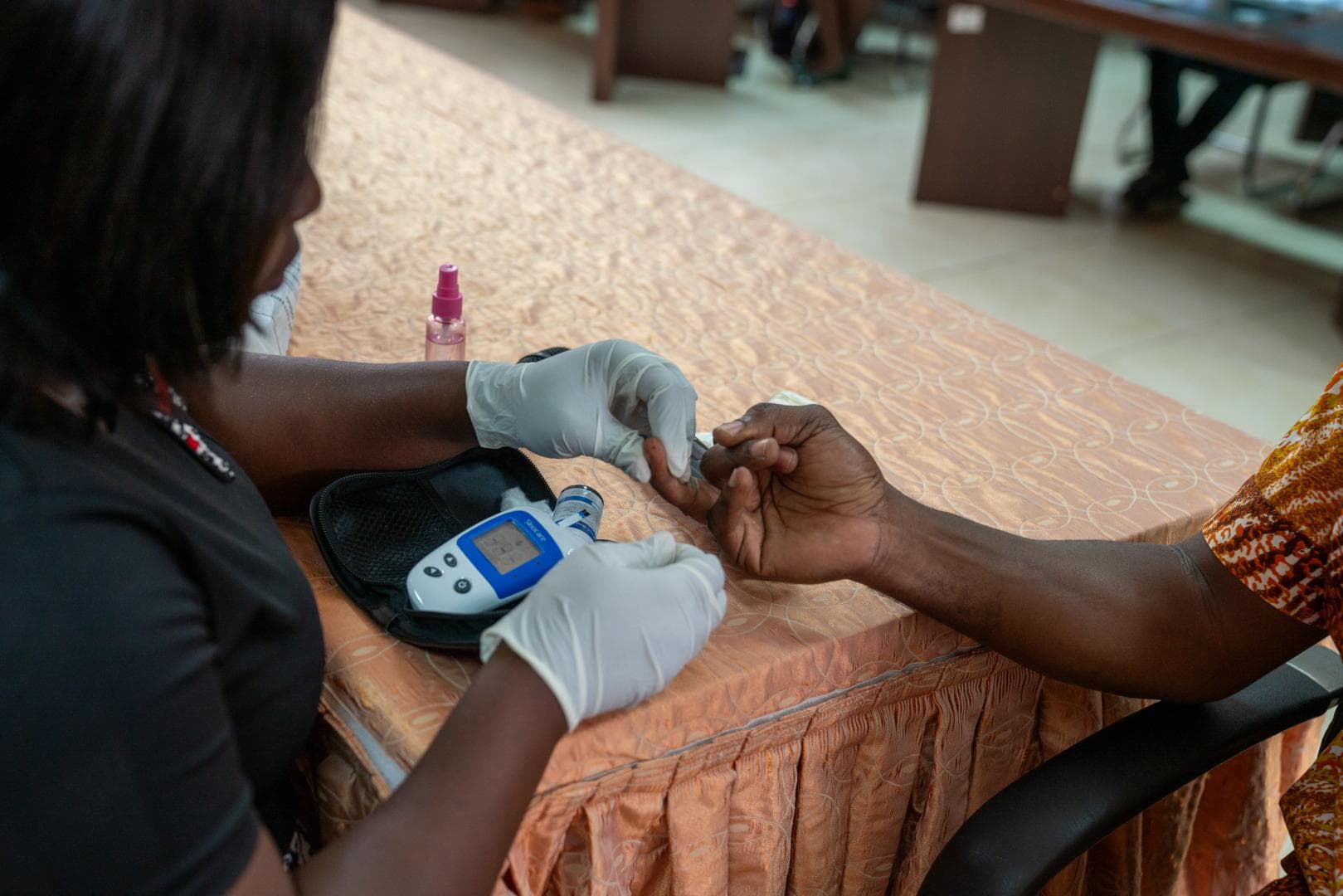 Healthcare provider conducting blood glucose testing